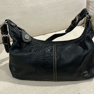 The Sak brand soft black leather purse.